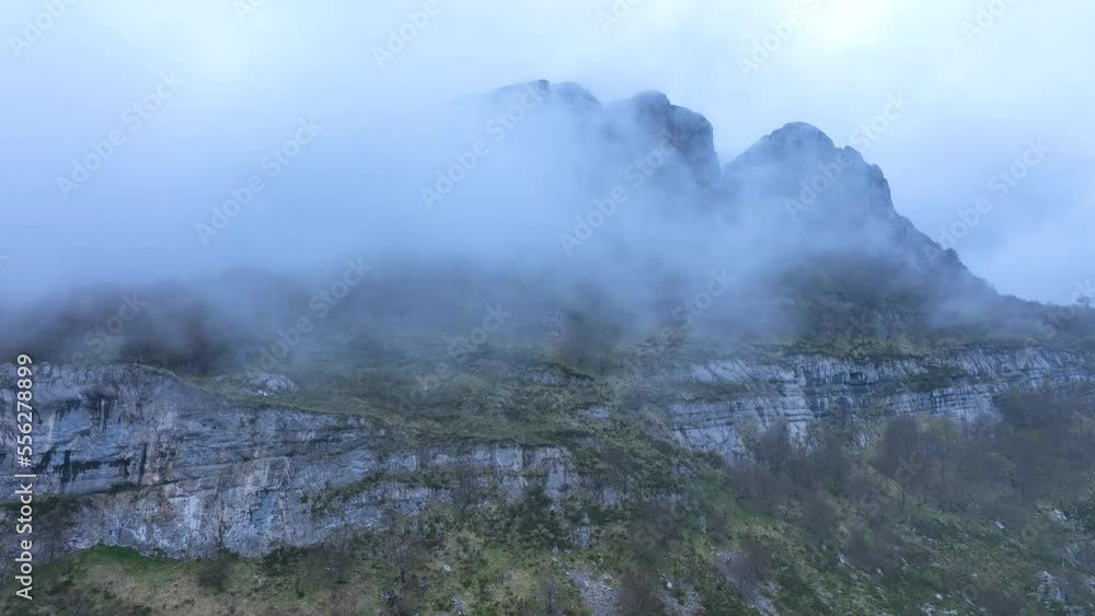 Landscape of fogs in the surroundings of the Ason river waterfall. Aerial view from a drone. Hills of the Ason Natural Park. Soba Valley, Cantabria, Spain, Europe Landscape of fogs in the surroundings of the Ason river waterfall. Aerial view from a drone. Hills of the Ason Natural Park. Soba Valley, Cantabria, Spain, Europe