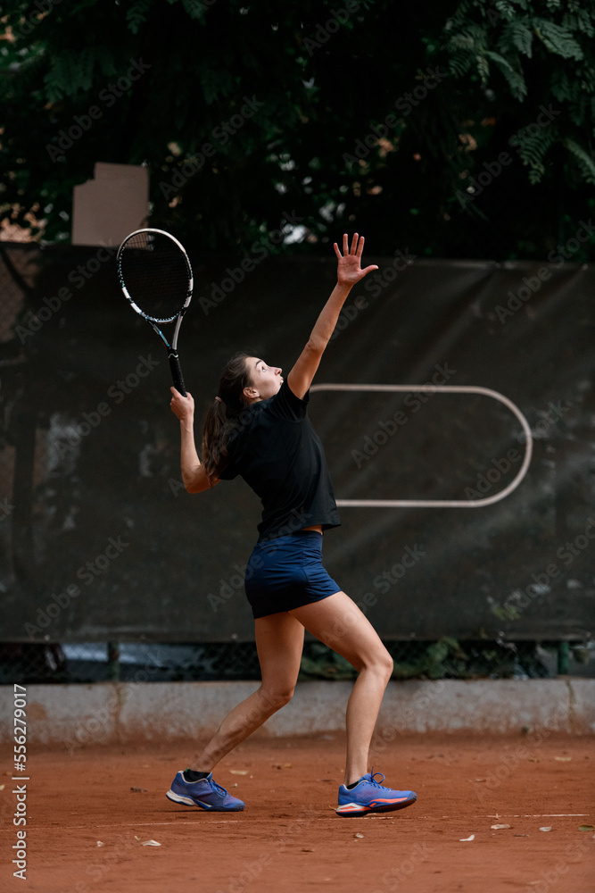 great view of sports female tennis player with tennis racket in her hand raised up