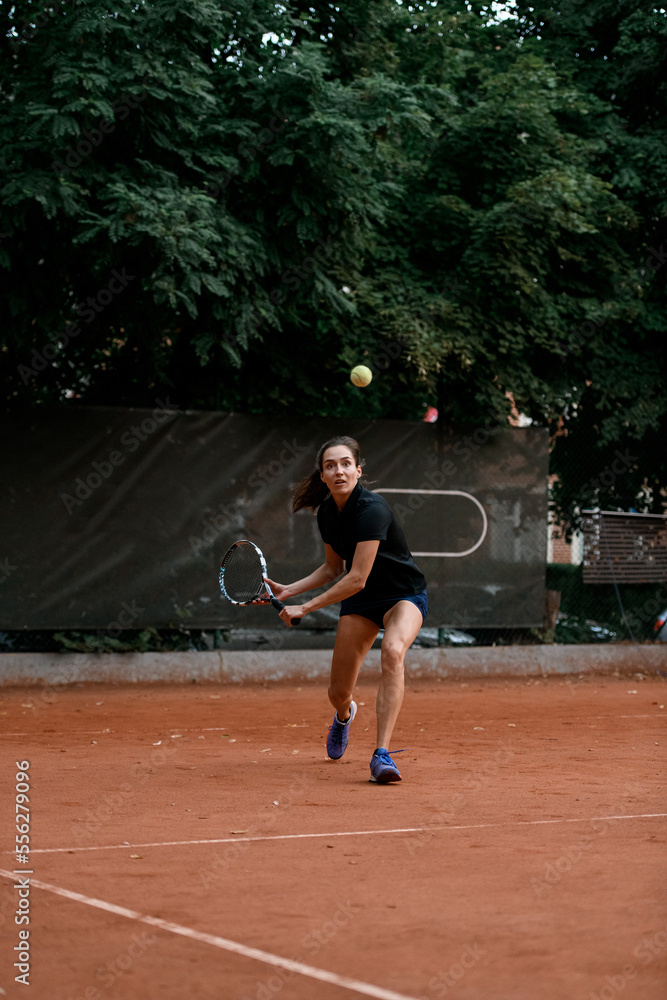 view on tennis ball and woman tennis player with tennis racket before hitting it