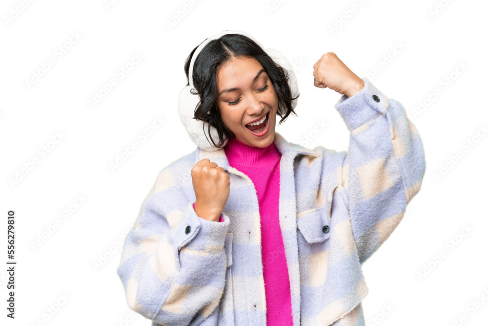 Young Argentinian woman wearing winter muffs over isolated background celebrating a victory Young Argentinian woman wearing winter muffs over isolated background celebrating a victory