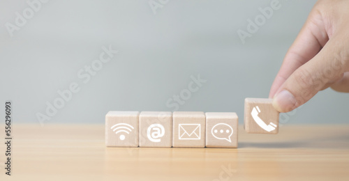 Website pageContact us or email marketing ideas Customer Support HotlineContact us Connecting people Wooden cubic handle with email, phone call, address, chat message icon