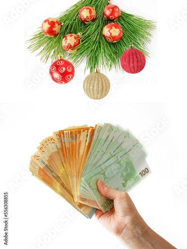 Cristmas greeting card with new year balls and decorations and hand holding big stack of euro money  merry christmas and happy new year  wealth in new year