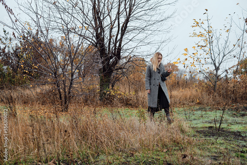 Girl walks in the autumn park. Beautiful autumn landscape, fall foliage. Outdoor activities. Autumn walk in nature. Enjoy the weather and fresh air. Travel and exploration © Iuliia Pilipeichenko