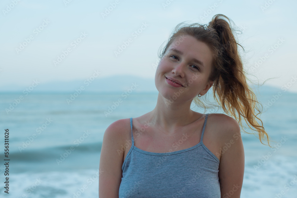 portrait young beautiful girl, on background embankment with sea, ocean and island view, smiling, relaxing, with closed eyes, sunset, deep breath fresh air portrait young beautiful girl, on background embankment with sea, ocean and island view, smiling, relaxing, with closed eyes, sunset, deep breath fresh air