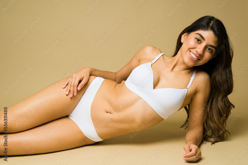 Gorgeous fit woman lying and relaxing in white underwear Gorgeous fit woman lying and relaxing in white underwear