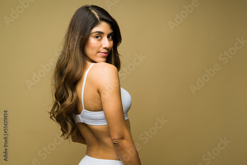 Gorgeous hispanic woman seen from behind wearing white underwear