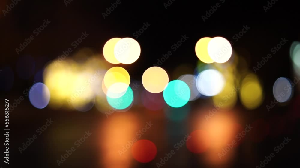 Bokeh car lights in the evening city. Defocused headlights and street lighting at night. Moving bokeh circles of cars at night. Blurred city traffic background Bokeh car lights in the evening city. Defocused headlights and street lighting at night. Moving bokeh circles of cars at night. Blurred city traffic background