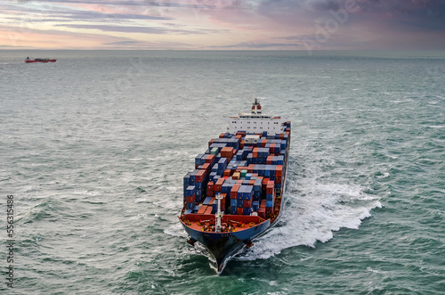 Nice aerial view of a giant container ship sailing at dawn in the English Channel