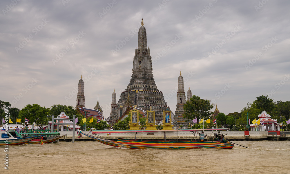 Naklejka premium View of Wat Arun Temple from the boat tour. Wat Arun is a Buddhist temple in the Yai district of Bangkok. It is one of the most popular tourist spots in Bangkok
