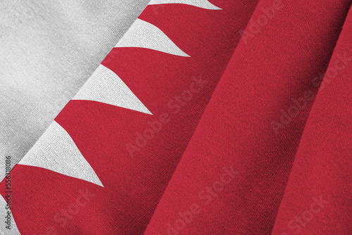 Bahrain flag with big folds waving close up under the studio light indoors. The official symbols and colors in fabric banner photo