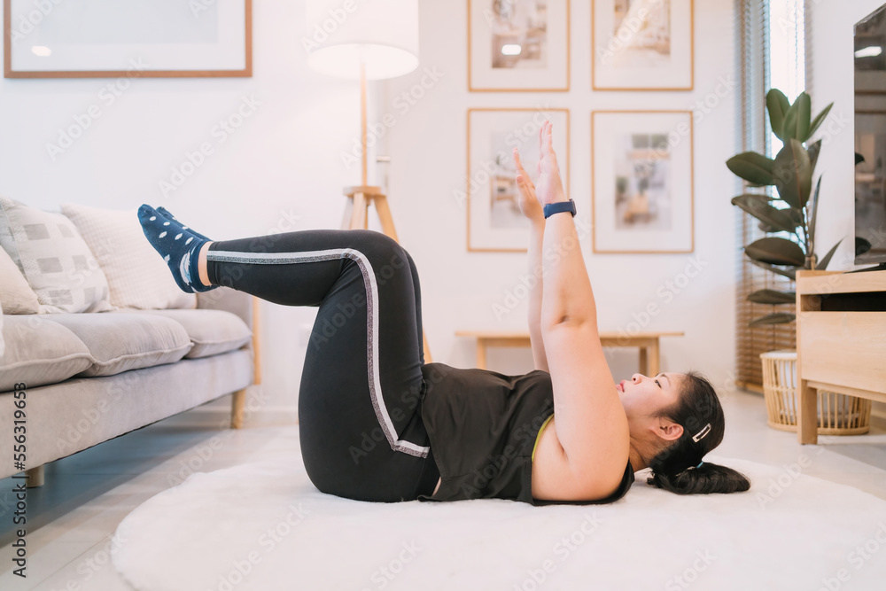 fat female person workout using couch in living room hip raise. overweight determined woman lying down legs on sofa exercising. motivated chubby woman trying hip raise pose on couch building muscle fat female person workout using couch in living room hip raise. overweight determined woman lying down legs on sofa exercising. motivated chubby woman trying hip raise pose on couch building muscle