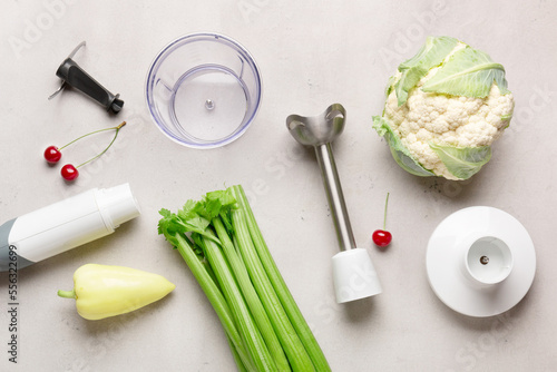 blender with fruits and vegetables on background

 photo