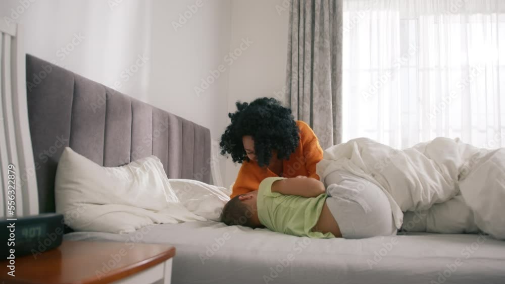 African American mother with son, diverse family play funny active game on bed in bedroom. Loving parent tickling adopted boy express caress, bonding and love. Fun and leisure at home concept slow mo African American mother with son, diverse family play funny active game on bed in bedroom. Loving parent tickling adopted boy express caress, bonding and love. Fun and leisure at home concept slow mo