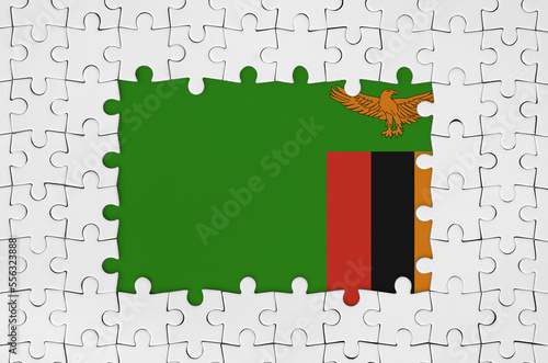 Zambia flag in frame of white puzzle pieces with missing central parts photo