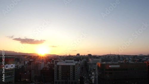 HAKATA, FUKUOKA, JAPAN - NOVEMBER 2022 : Aerial high angle view of cityscape of Fukuoka city in sunset. View of Tenjin and Nakasu downtown area from Hakata station. photo