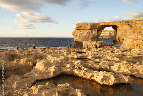 Famous Azure Window in Malta, this stone formation collapsed in 2017, dramatic view of a rocky coastline, warm sunlight