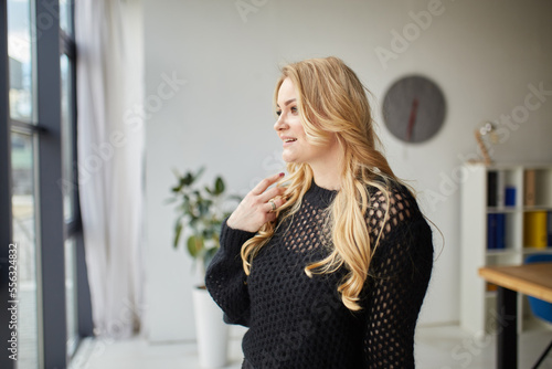 Portrait of blonde girl with makeup in black fashion clothes