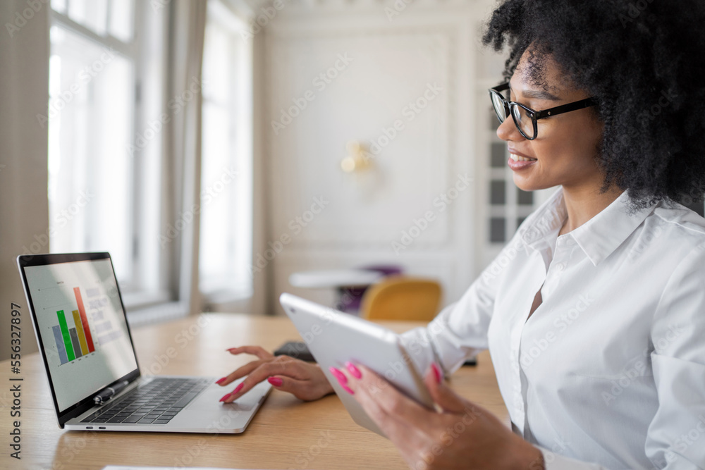 A young woman with glasses and a white shirt in the office is typing a message using a laptop education. A freelancer is working on a new online project site. A young woman with glasses and a white shirt in the office is typing a message using a laptop education. A freelancer is working on a new online project site.