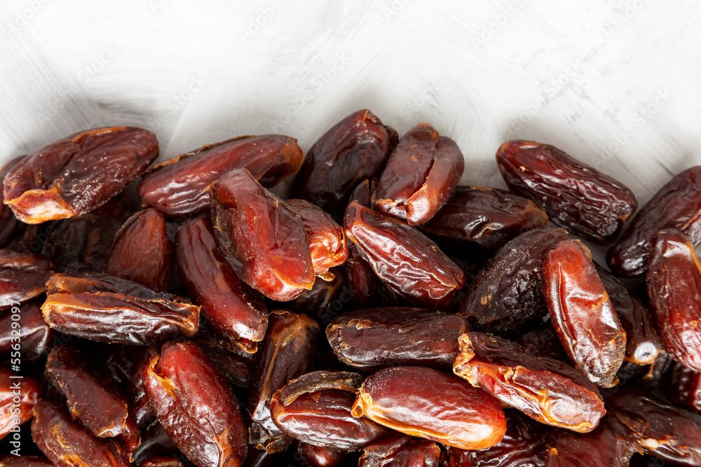 Pitted Organic Dates on gray background, top view. Flat lay, overhead, from above. Copy space. Pitted Organic Dates on gray background, top view. Flat lay, overhead, from above. Copy space.