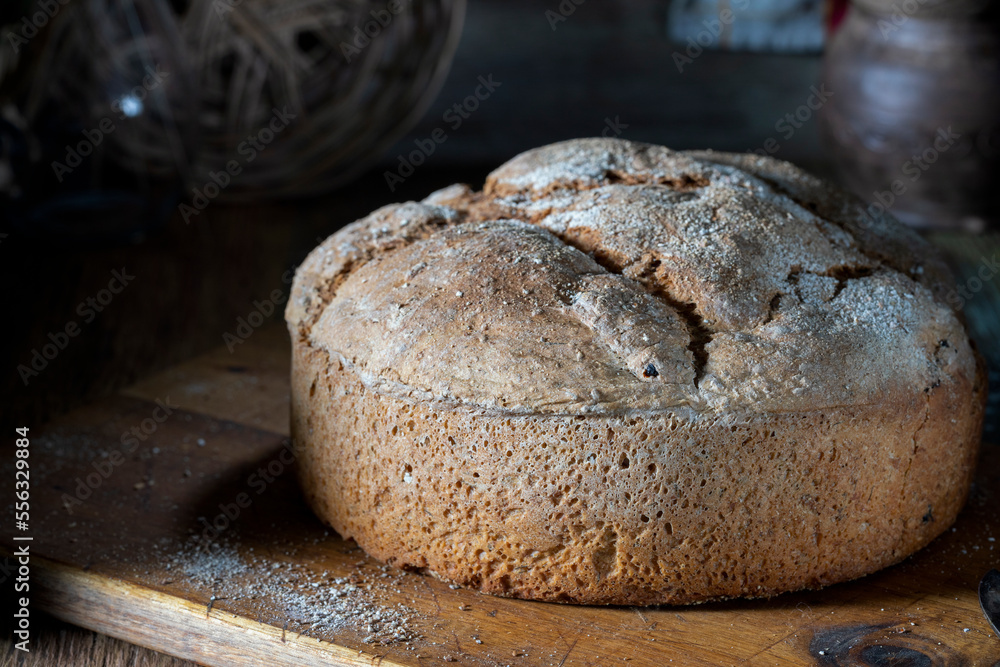 Round wheat homemade bread on a rustic table Round wheat homemade bread on a rustic table