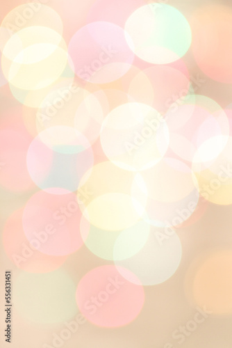 Blurred colored lights on light pink background