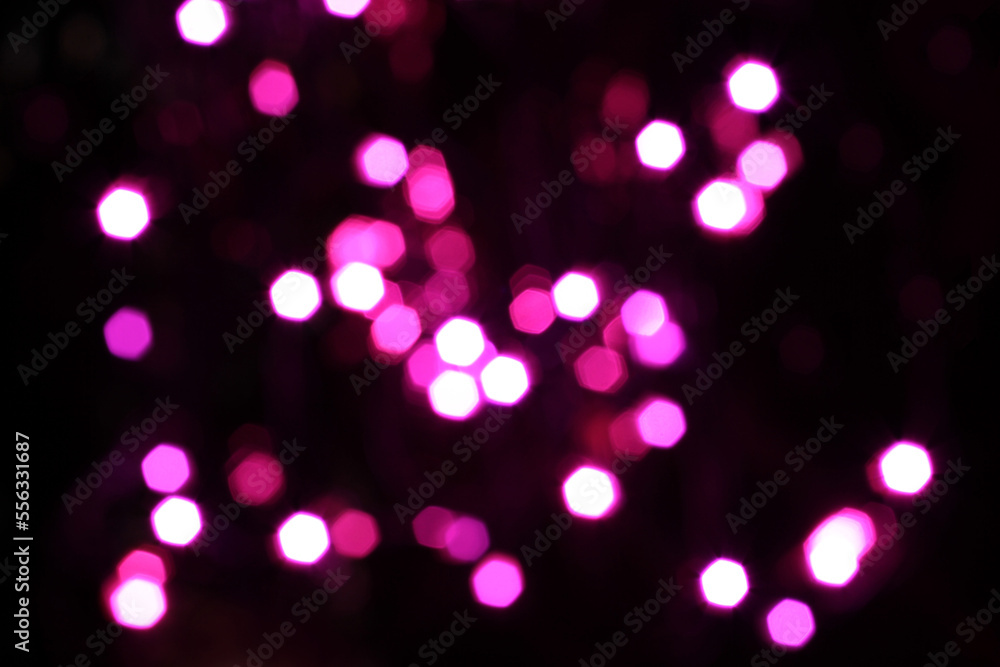 Blurred  white, pink and magenta lights on black background