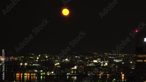 Wallpaper Mural FUKUOKA, JAPAN - NOV 2022 : Aerial high angle view of Fukuoka City and full moon. Time lapse shot at night. View around Tenjin and Nakasu downtown area. Travel and urban city nightlife concept video. Torontodigital.ca