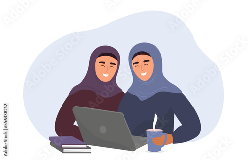 Muslim girls in hijabs are sitting at a laptop. Female students study and work online. Vector graphics.