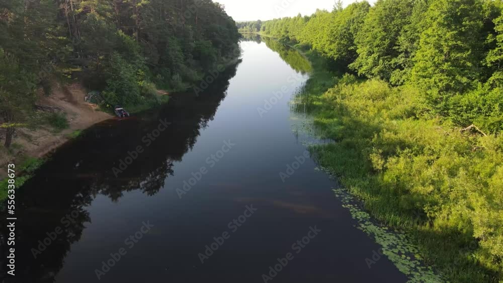 Aerial drone view of the river and green forests and fields on a summer day. Aerial drone view of the river and green forests and fields on a summer day.