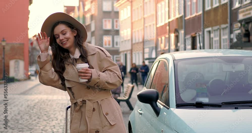 A cute European girl smiles and wait taxi A cute European girl smiles and wait taxi