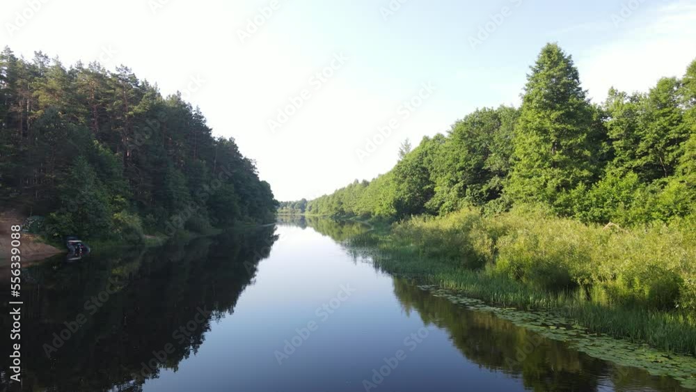 Aerial drone view of the river and green forests and fields on a summer day. Aerial drone view of the river and green forests and fields on a summer day.