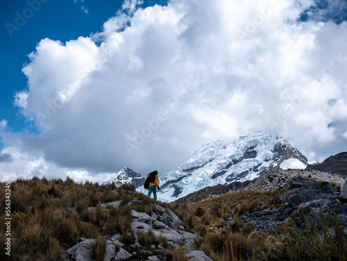 Woman tourist walking towards the glacier on a mountain  in Peru South America