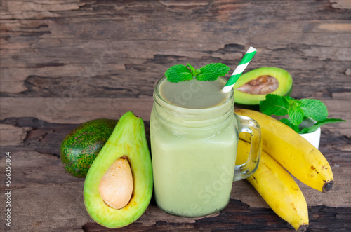 Avocado and Banana fresh cocktail smoothies  fruit juice beverage healthy the taste yummy in glass drink episode good morning on wooden background.