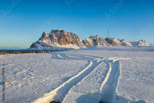 Fantastic winter scenery on Uttakleiv beach at morning with car tracks