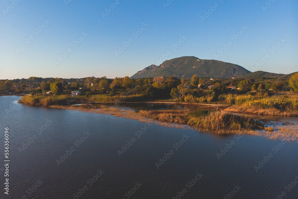 Fototapeta premium Beautiful aerial vibrant view of Korission Lake Lagoon landscape, Corfu island, Greece with pink flamingos flock, Ionian sea beach and mountains in a summer sunny day