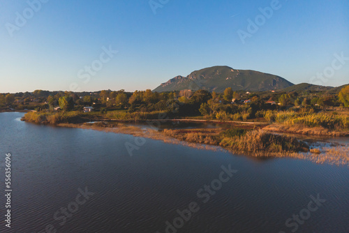 Beautiful aerial vibrant view of Korission Lake Lagoon landscape  Corfu island  Greece with pink flamingos flock  Ionian sea beach and mountains in a summer sunny day