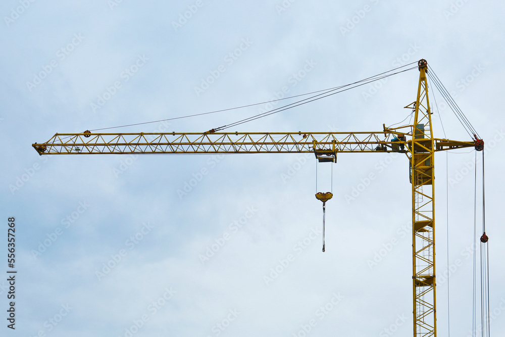 Modern tower crane against cloudless sky. Construction site Modern tower crane against cloudless sky. Construction site