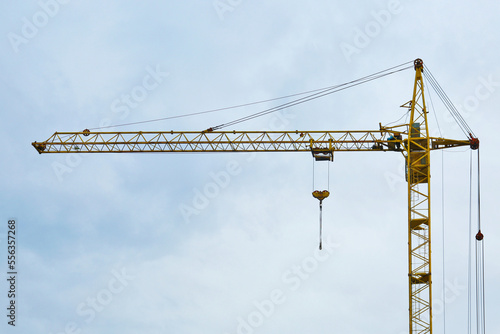Modern tower crane against cloudless sky. Construction site