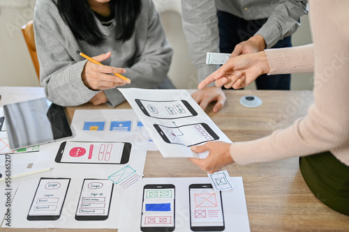 Photography Team of professional mobile application developers checking and testing their ne