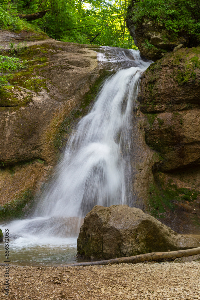 A mountain river in a natural channel with rapids and waterfalls. A mountain river in a natural channel with rapids and waterfalls.