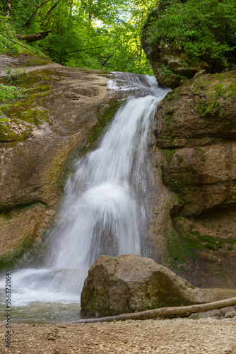 A mountain river in a natural channel with rapids and waterfalls.