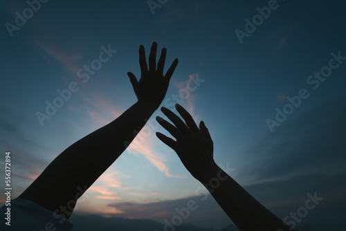 Silhouette of hand gesture against the sky. Concept of freedom.