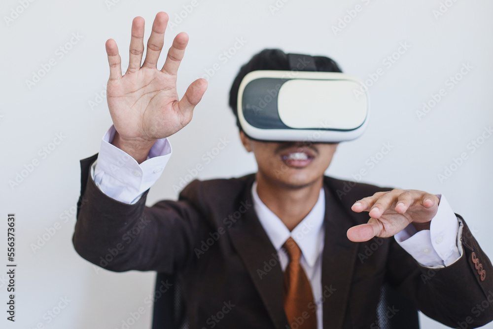 Close-up of businessman in suit using VR glasses and gesturing hands. Close-up of businessman in suit using VR glasses and gesturing hands.