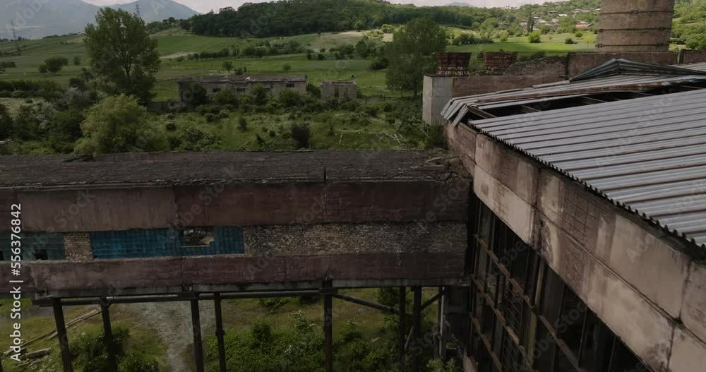 Ruins Of Abandoned And Damaged Factory Building In Khashuri, Georgia. aerial flyby Ruins Of Abandoned And Damaged Factory Building In Khashuri, Georgia. aerial flyby