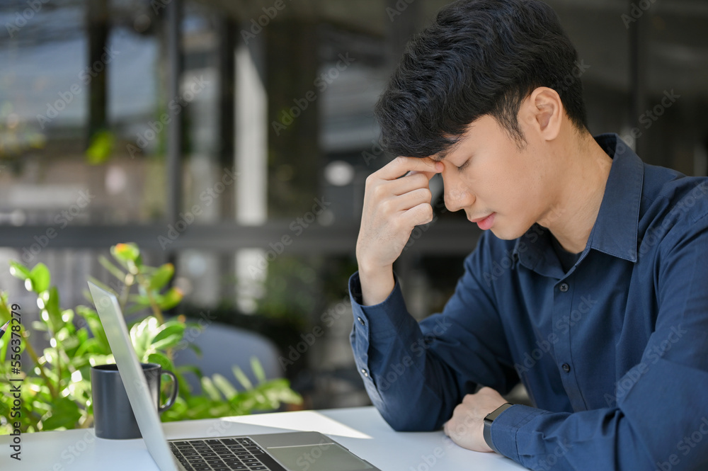 Young businessman stressed about his project and have a headache during work time. Young businessman stressed about his project and have a headache during work time.