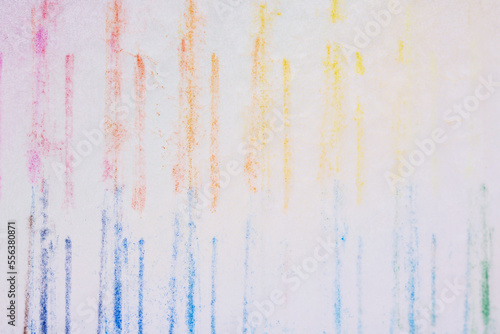 Coloring with various colors of crayons on a white background