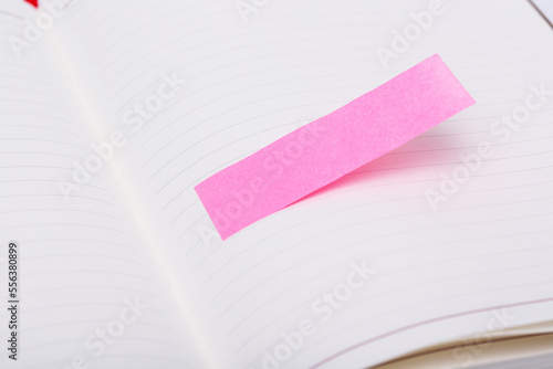 a pink note in an open notebook