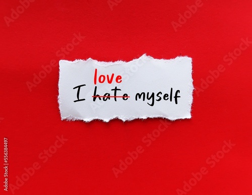 Torn paper on red background with handwritten I HATE MYSELF,  replaced with I LOVE MYSELF, concept of develop self worth, catch negative inner critic and change to positive affirmtation