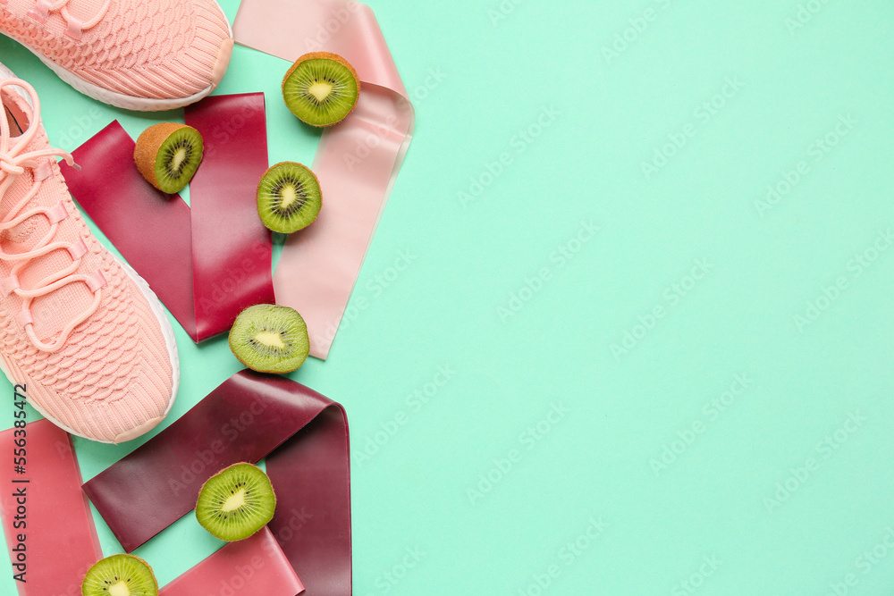 Resistance bands, shoes and kiwi on color background Resistance bands, shoes and kiwi on color background