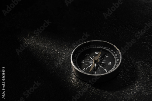 Black compass on dark background